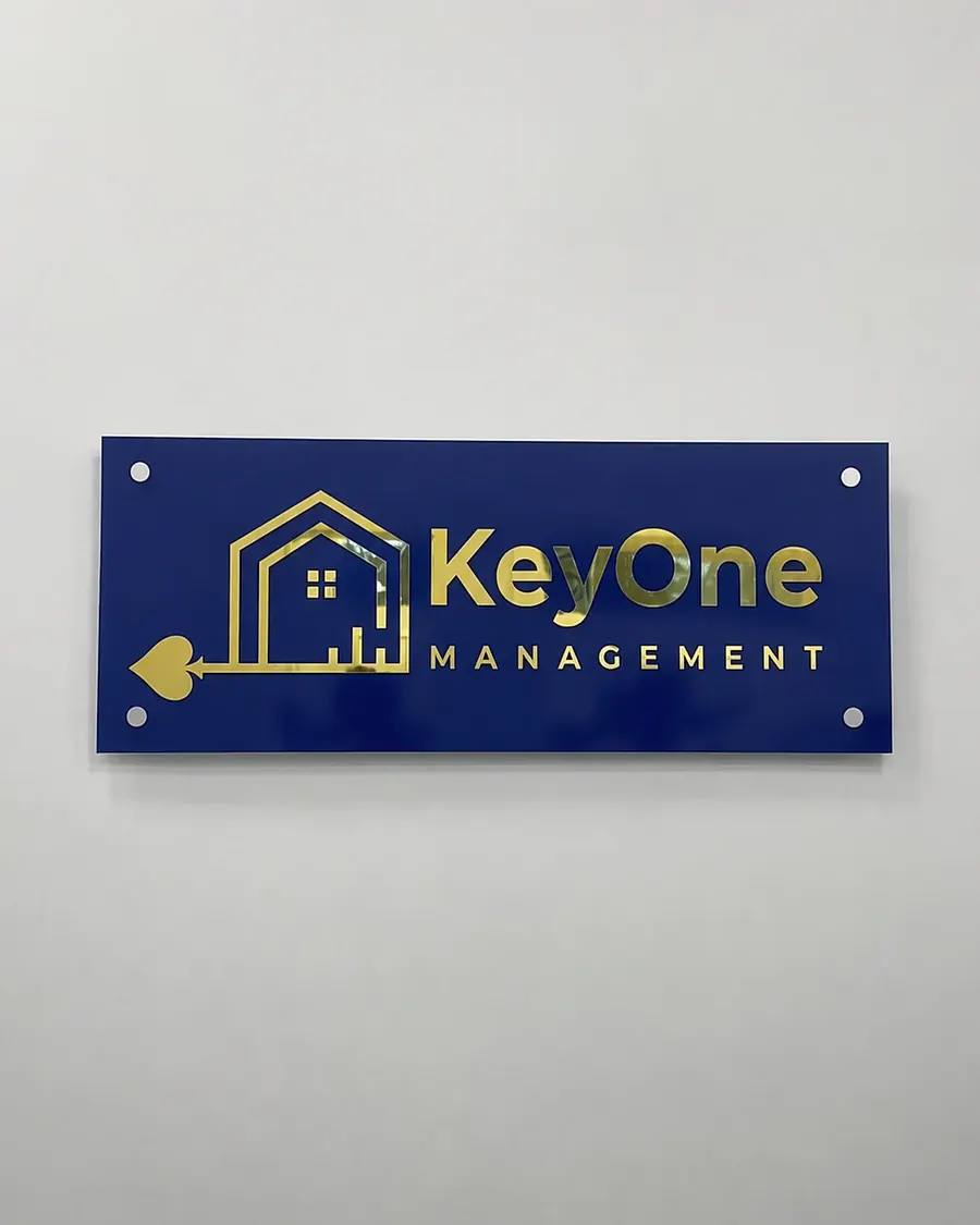 KeyOne Management in gold on a blue acrylic plaque