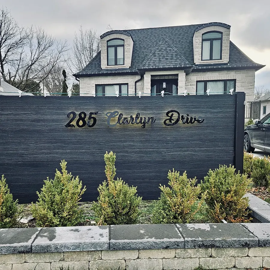 285 Florlyn Drive on a dark garden wall