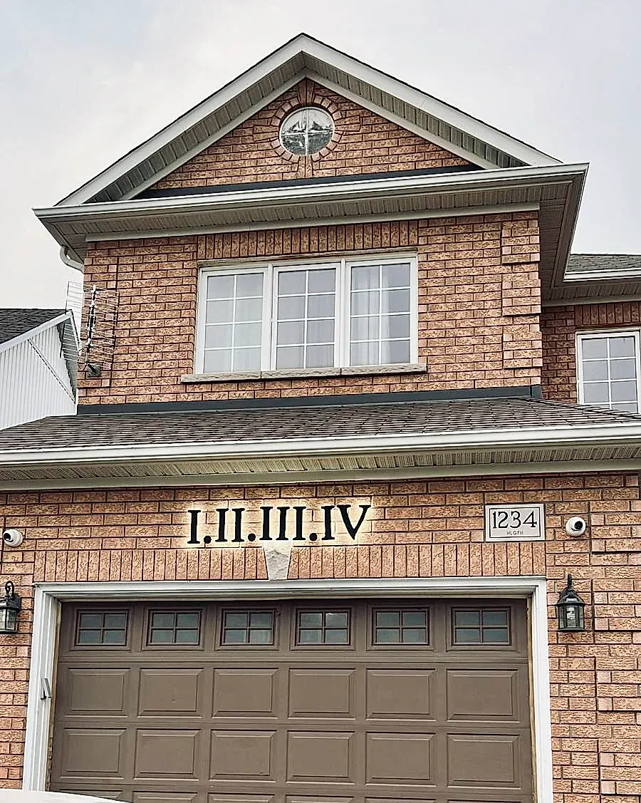 I II III IV in roman numerals on a red brick gable
