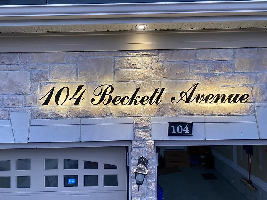 104 Beckett Avenue lit above a stone-clad garage
