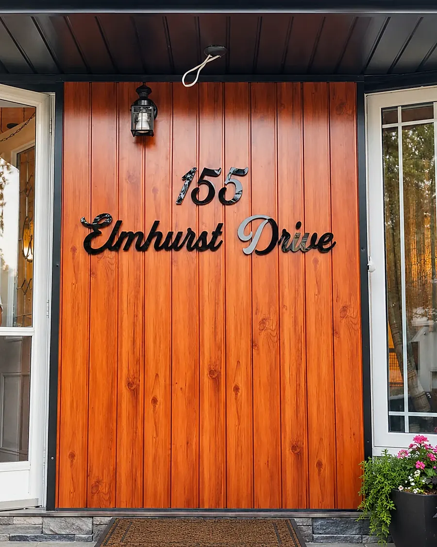 156 Elmhurst Drive in white script on an orange timber door